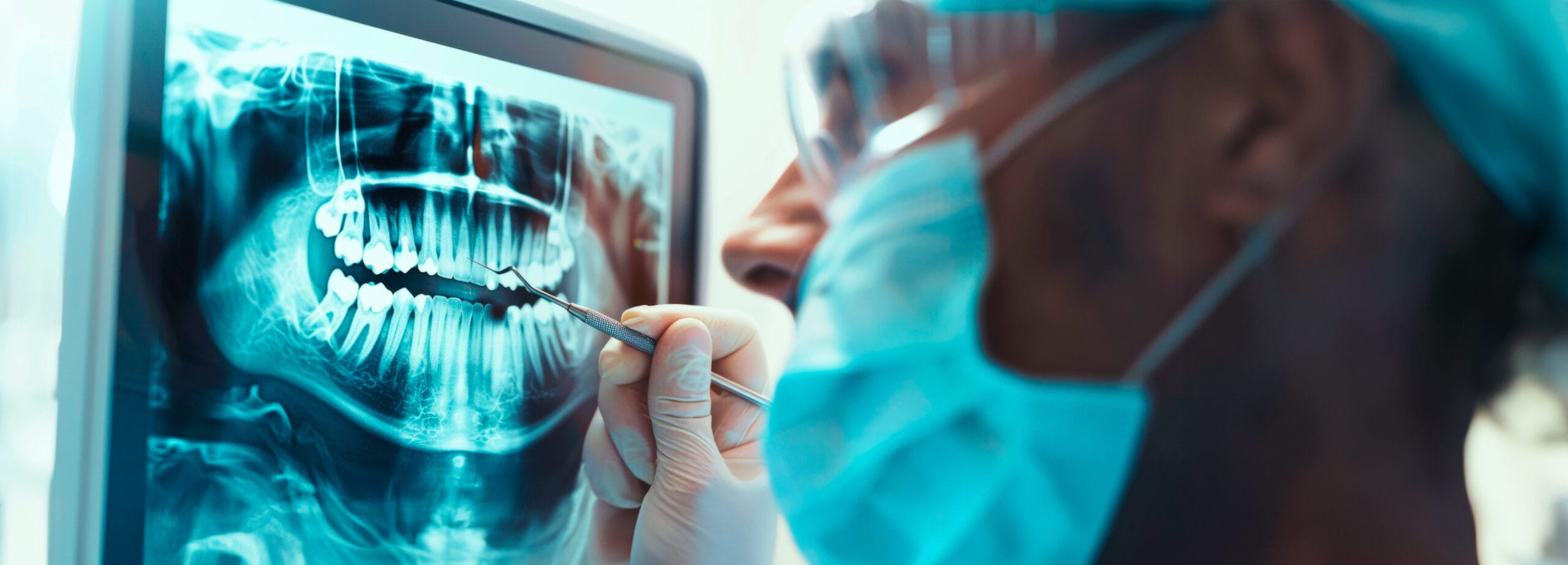 Healthcare professional examining dental x-ray