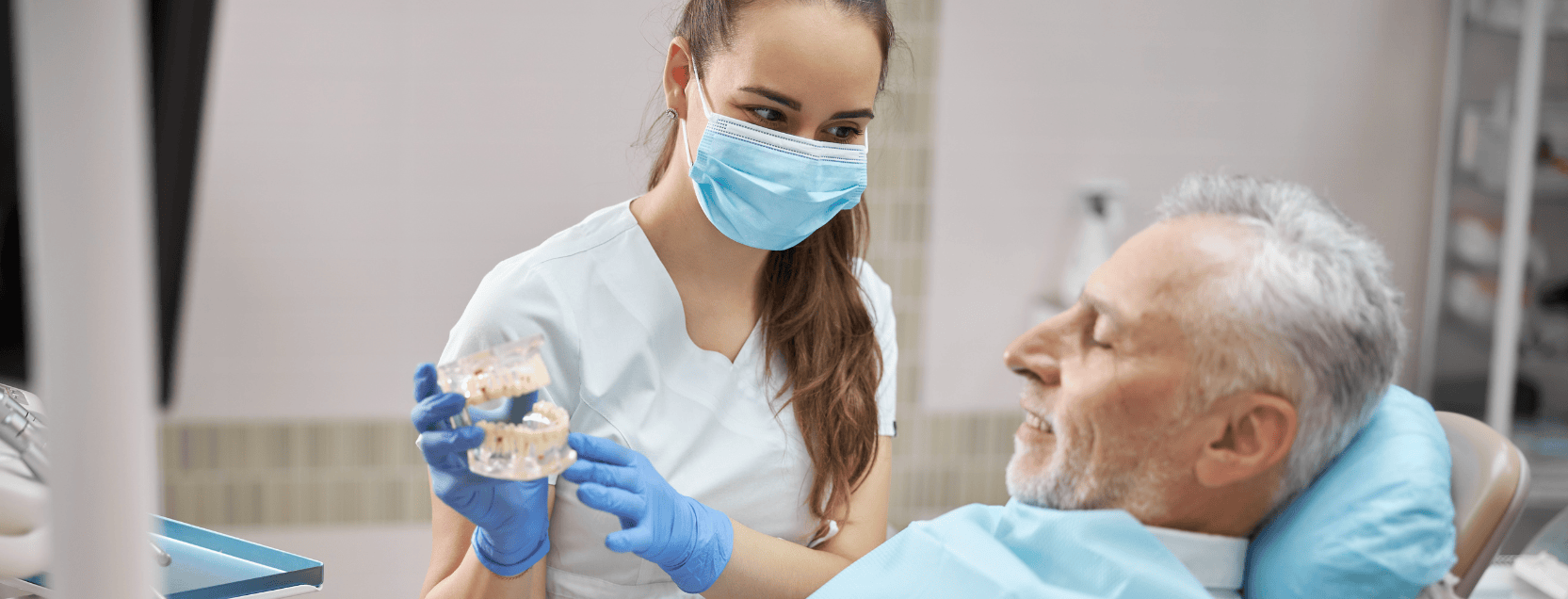 dentist showing patient what dental implants look like