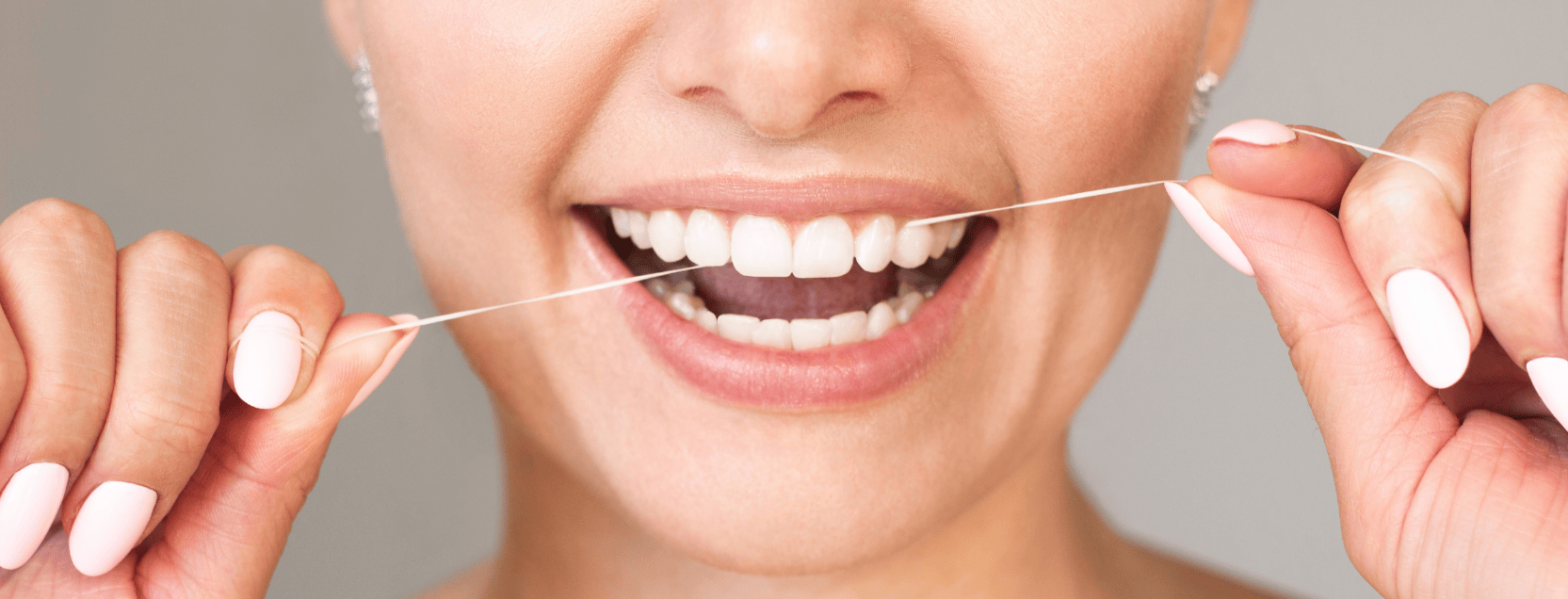 woman flossing her teeth