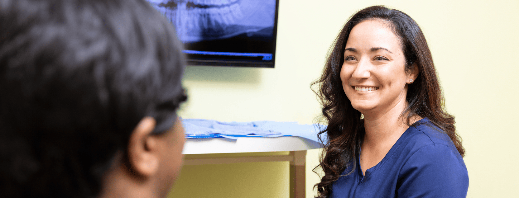 dental hygienist smiling at patient